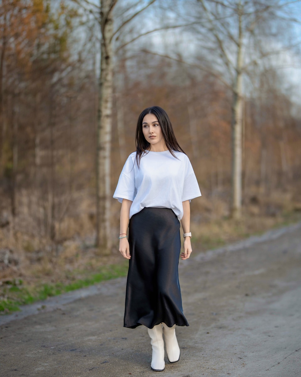 a woman in a white shirt and black skirt