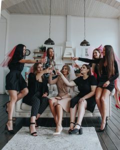 group of women sitting on white floor