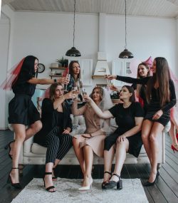 group of women sitting on white floor