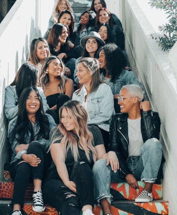 group of people sitting on gray concrete stairs